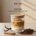 Chocolate coffee scented candle in glass jar with coffee beans, vanilla, and cinnamon