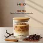 Chocolate coffee scented candle in glass jar with coffee beans, vanilla, and cinnamon