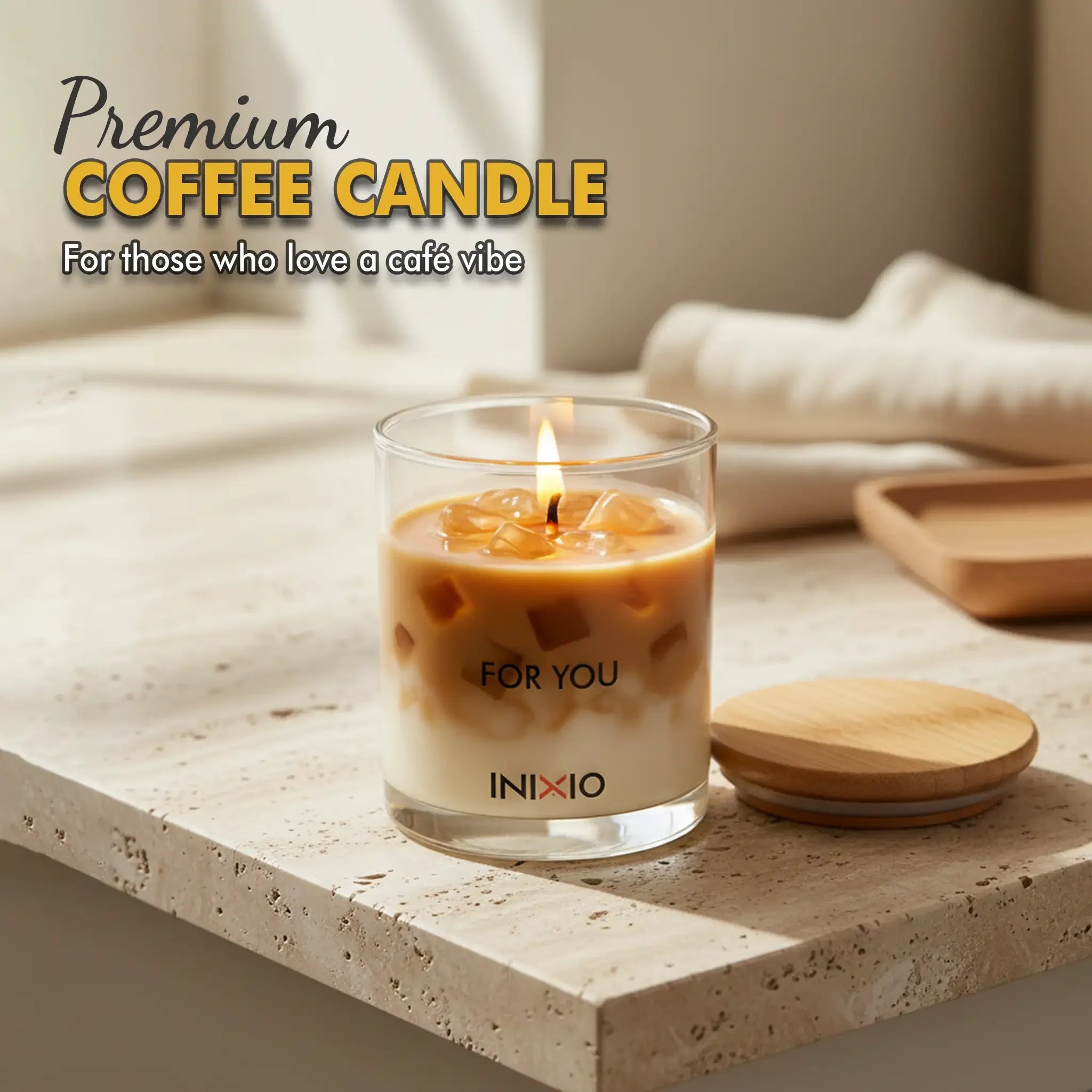 Premium coffee-scented soy wax candle in glass, lit on a stone tabletop with wooden lid nearby.