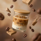 Coffee-scented soy wax candle in glass jar with coffee beans and wood blocks, aromatic decor.