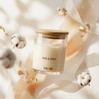Glass soy wax scented candle with wooden lid, cotton flowers, and decorative ribbons