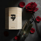 Long-lasting women's perfume bottle with wooden box, rose, and red petals on stone background