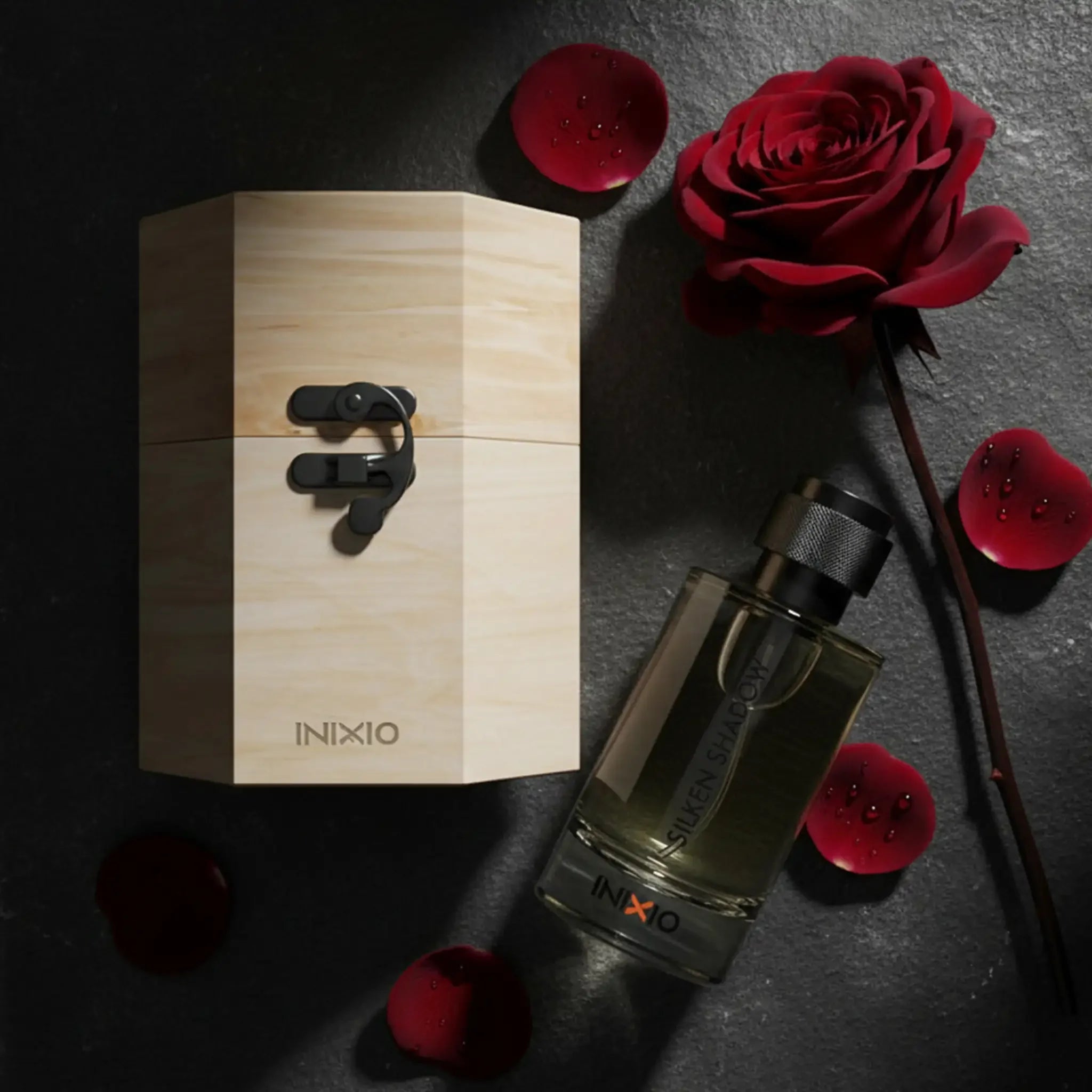Long-lasting women's perfume bottle with wooden box, rose, and red petals on stone background