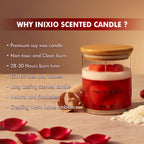 Red and white soy wax candle with heart shapes in glass jar, surrounded by rose petals, wood shavings, and wax beads.